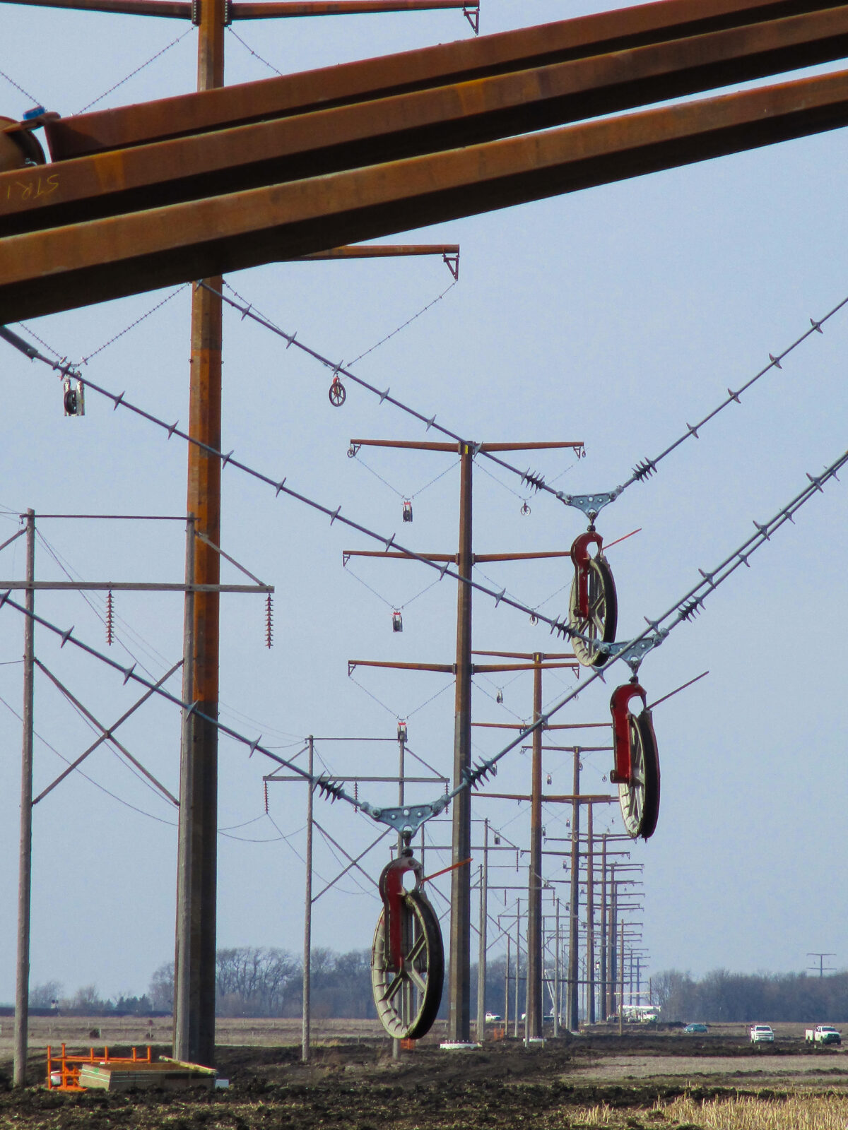 A row of transmission lines extending to the horizon